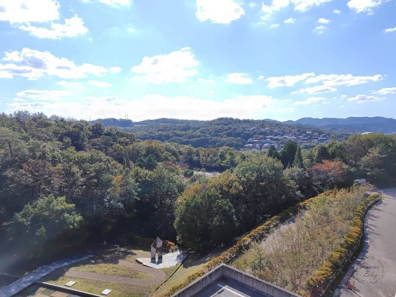 屋外のテラスから見た里山と町並み